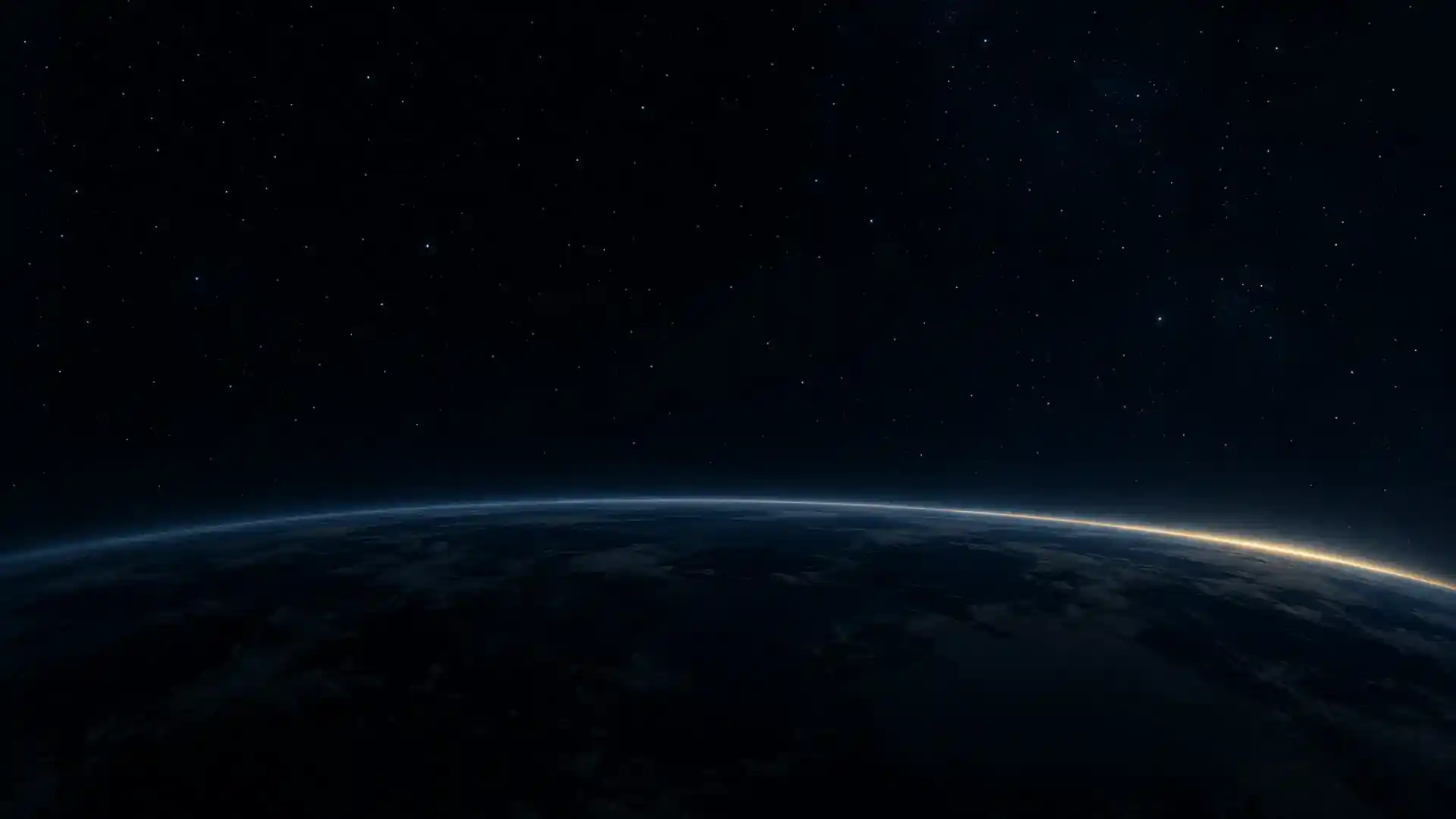 La Tierra de noche vista desde la órbita, con la primera luz del amanecer en el horizonte.